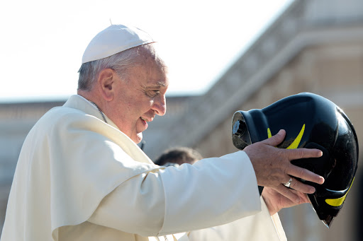 Pope Francis wears a firefighter&#8217;s helmet