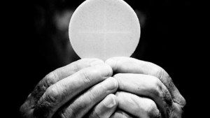 A priest holds eucharist – it