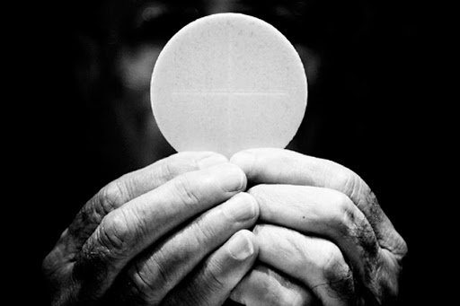 A priest holds eucharist &#8211; it
