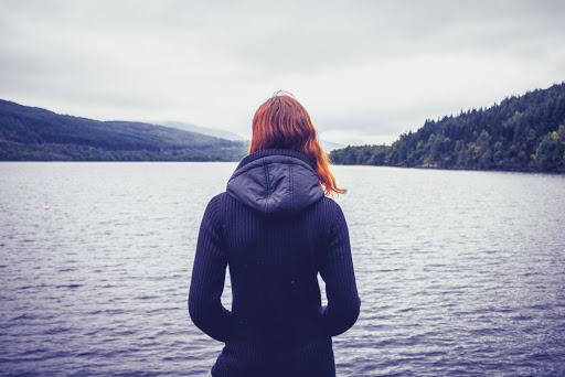 Woman admiring stillness of the lake &#8211; it