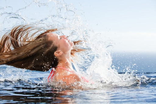 woman raising her head out of the water in a swimming &#8211; it