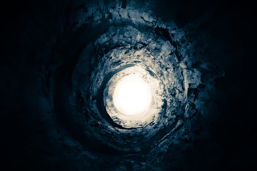 Dark-blue tunnel leading to the rotating light &#8211; it