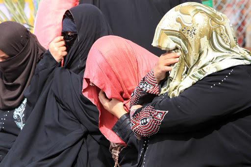 Iraqi female detainees hide their faces after being freed on February 28, 2013 in the Iraqi capital Baghdad. &#8211; it