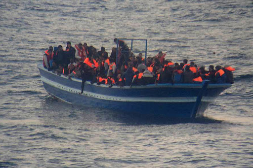 MEDITERRANEAN SEA &#8211; migrants standing on a boat &#8211; it