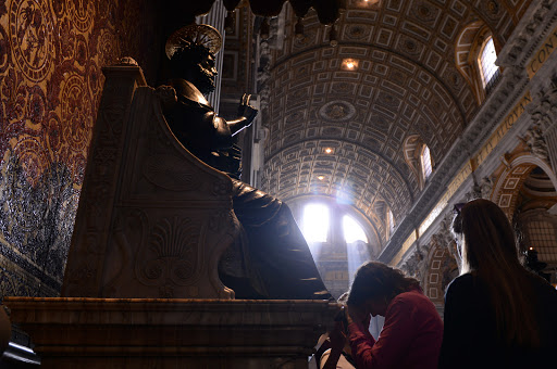 Pilgrims praying in St. Peter&#8217;s Basilica