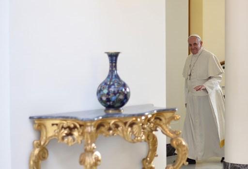 Pope Francis walks in the hall of Santa Marta