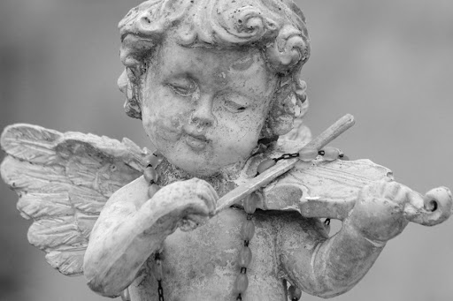 little angel playing violin &#8211; detail of cemetery decor, Italy &#8211; it