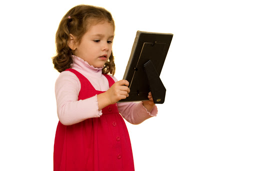 Little girl looking at a picture