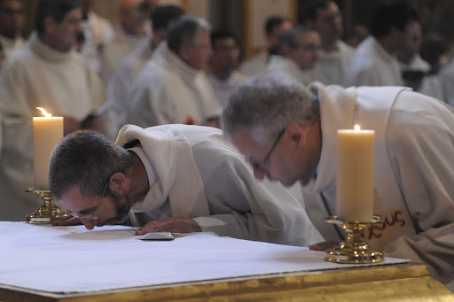 A priest is kissing the altar &#8211; it