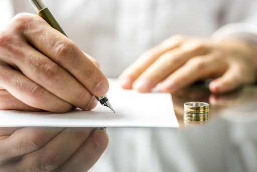 A man signing divorce papers