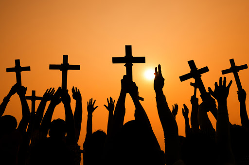 Crosses held up at sunset