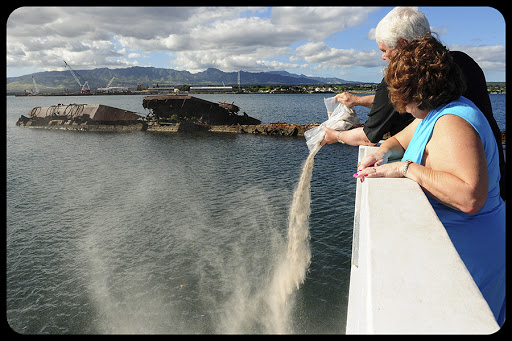 Harry and Carole Knight, son and daughter of Chief Petty Officer Robert C. Knight, scatter his ashes above the waters at the USS Utah Memorial during an ash scattering ceremony held in his honot &#8211; it