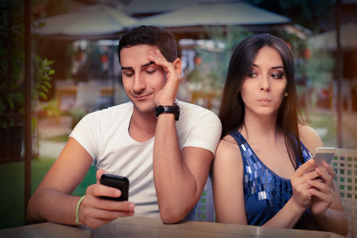 Secretive Couple with Smart Phones in Their Hands &#8211; Young adult couple has privacy problems with modern technology &#8211; it