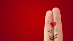 A happy couple in love with painted smiley and hugging © Preto Perola / Shutterstock