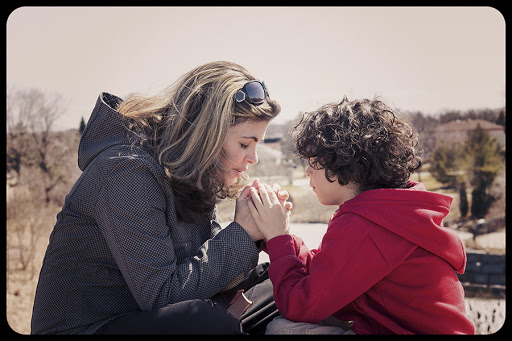 Mother and her son having a devotional outdoors © Rmnoa357 / Shutterstock &#8211; it