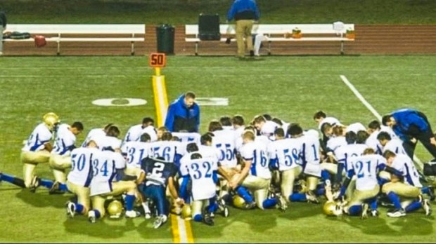 Coach pray with his players