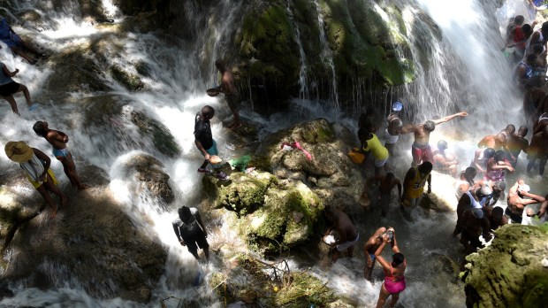 web-bath-haiti-religion-falls-carmel-000_da0y5-afp-photo-hector-retamal-ai
