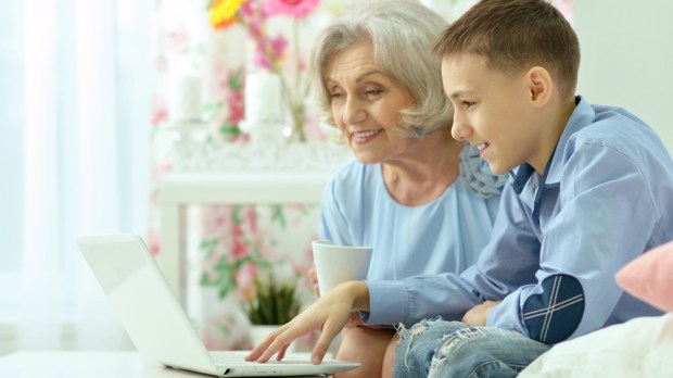 grandmother playing internet with grandson