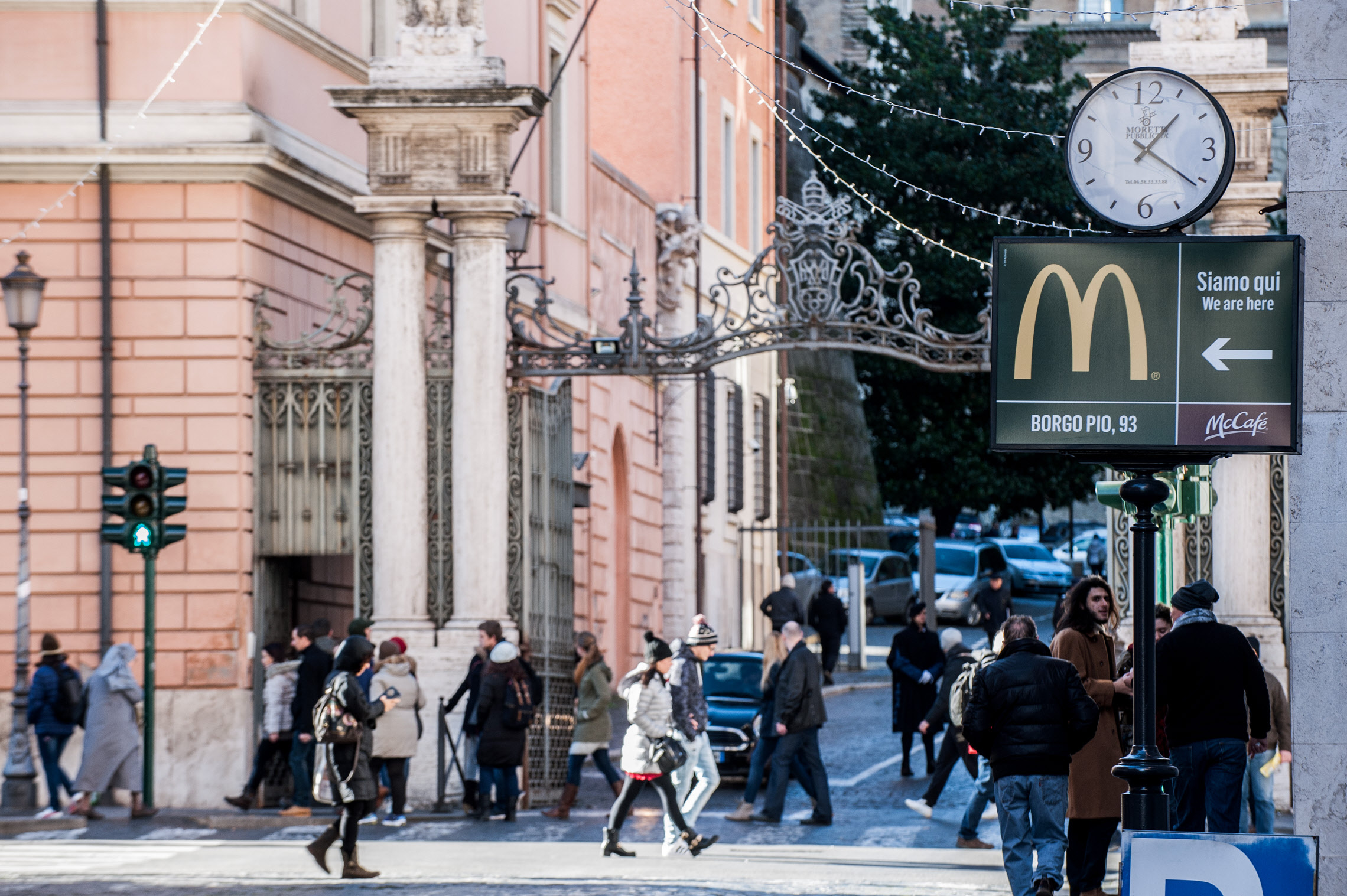 January 5 2017 : A sign showing the direction of a McDonald restaurant is seen near an entrance of the Vatican in the background.