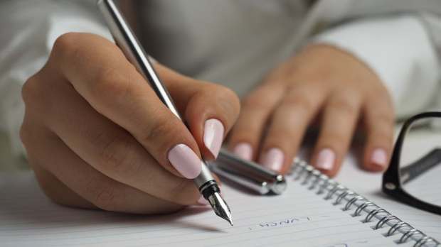 hand writing paper pen