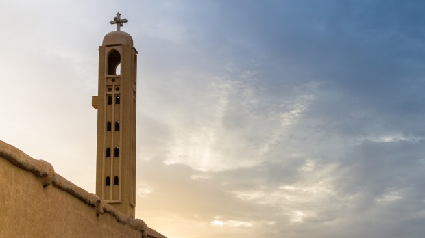 Coptic Monastery with Cross Stone tower at sunset