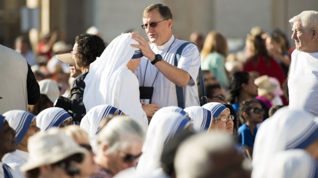 A priest blessing a nun of the missionary of charity