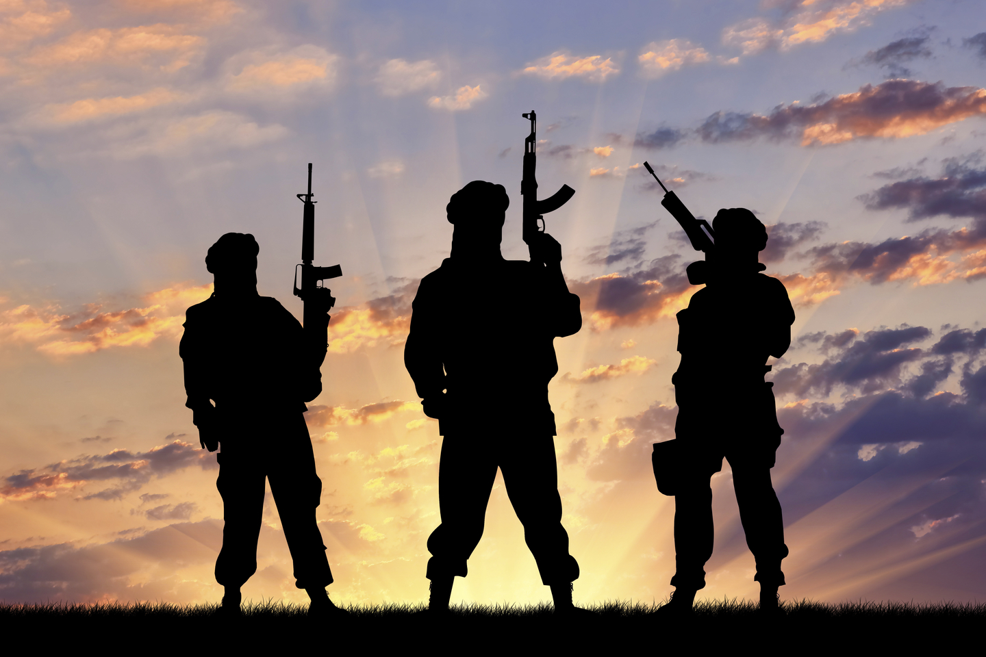 Concept of a terrorist. Silhouette terrorists with rifle at sunset