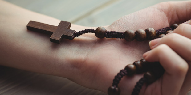 web3-hand-woman-rosary-beads-wood-brown-shutterstock_316798295-shutterstock