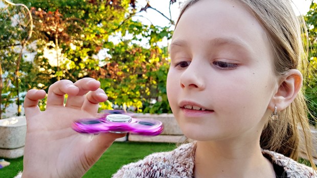 WEB3 LITTLE GIRL FIDGET SPINNER PARK CHILD FAD Shutterstock