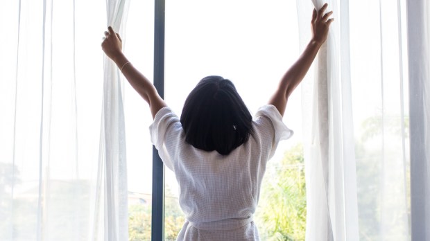 WOMAN OPENING WINDOW