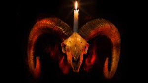 Skull of ram with lighted candle – Baphometh symbol from Taro cards
