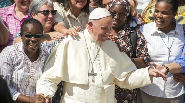 Pope Francis poses with faithful