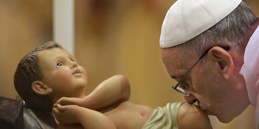 Pope Francis kisses the unveiled baby Jesus during a Christmas Eve mass at St Peter&#8217;s Basilica &#8211; pt