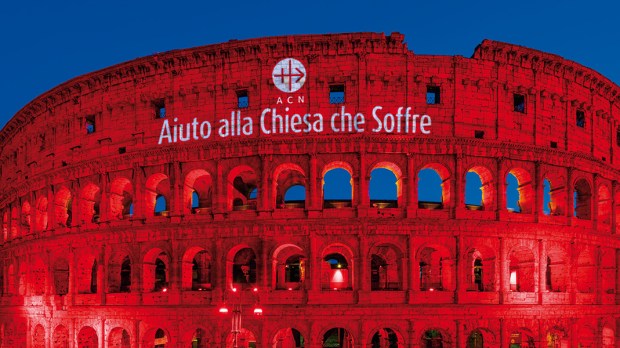 red colosseum Aiuto alla Chiesa Che Soffre