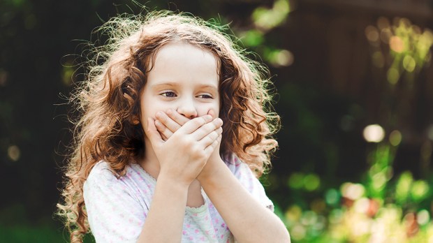 CHILD COVERING MOUTH