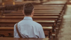 MAN SITTING IN PEW