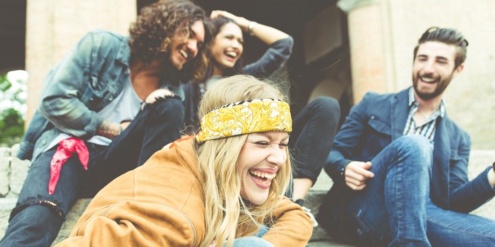 GROUP OF FOUR FRIENDS LAUGHING