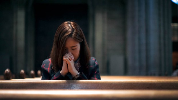 WOMAN PRAYING,CHURCH PEWS