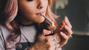WOMAN SMOKING CANNABIS