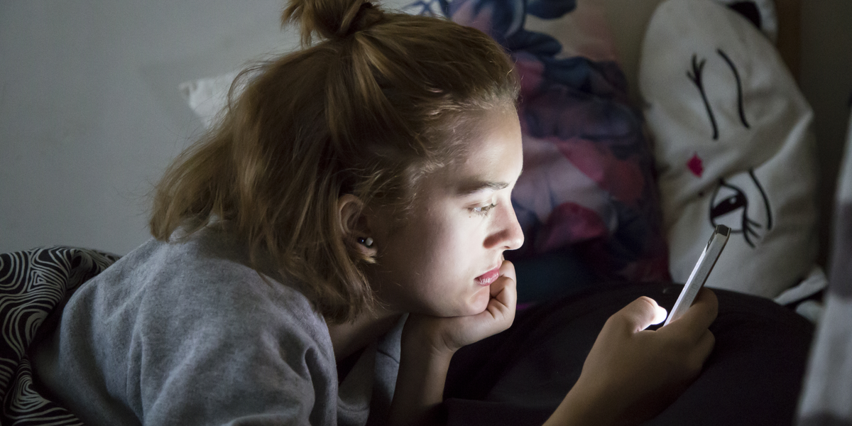 web2-teenage-girl-looks-on-her-smartphone-in-bed-during-the-night-shutterstock_547499824.png