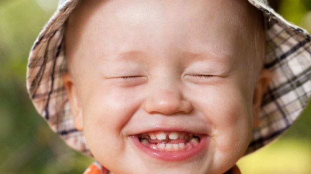 child smiles with teeth