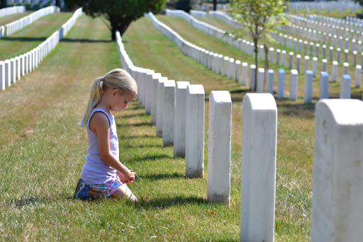 Young girl praying in cemetery – ar