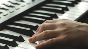 WEB3-A-woman-is-playing-a-synthesizer.-In-the-frame-one-hand-side-view-Shutterstock_680368825.jpg