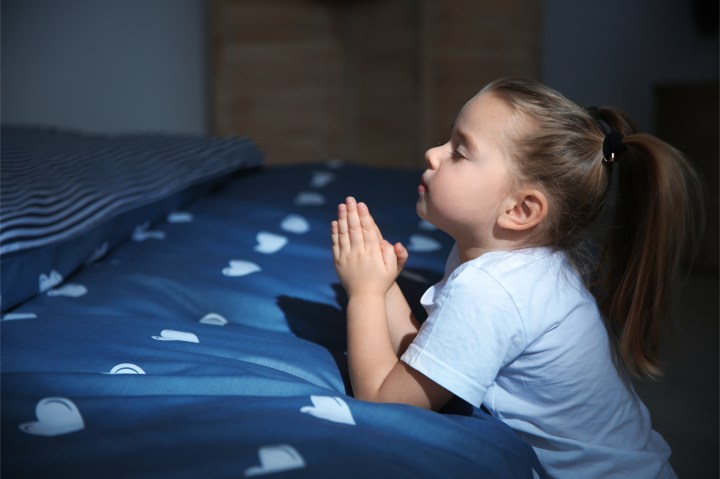 LITTLE GIRL PRAYING IN BED,