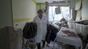 A medical worker walks inside of the damaged by shelling maternity hospital in Mariupol, Ukraine