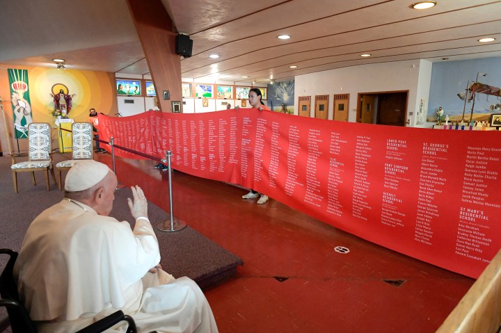 Pope-Francis-blessing-a-banner-with-names-of-victims-of-abuse-committed-at-residential-schools-run-by-the-Catholic-Church-AFP
