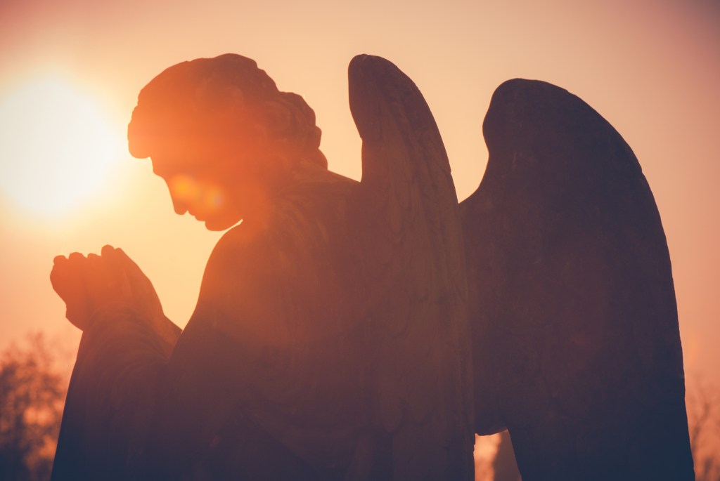 guardian angel sculpture at sunset