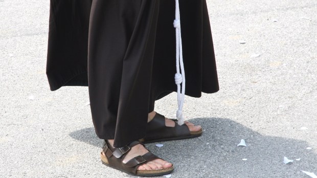 Barefoot with sandals and the habit of a Franciscan Friar