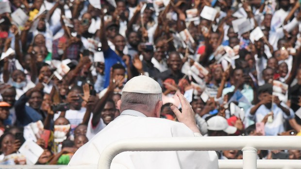 Pope-Francis-waves-as-he-arrives-by-popemobile-for-a-meeting-with-young-people-and-catechists-at-Martyrs-Stadium-in-Kinshasa-AFP